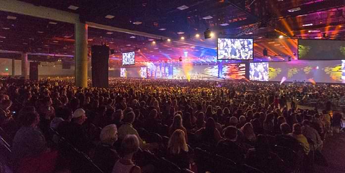 Attendees pack an exhibit hall during a keynote session.